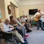 care home residents listing to music performance