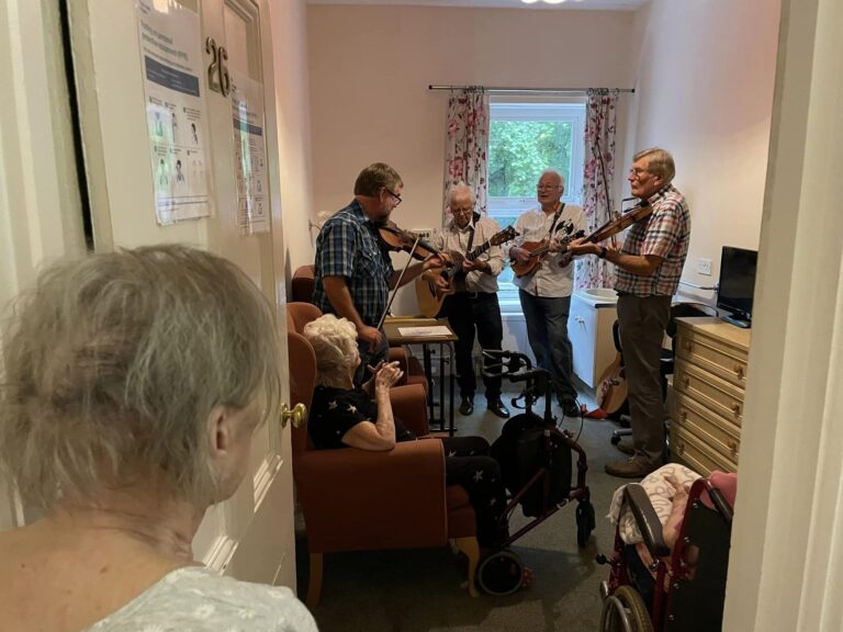 care home residents listening to band