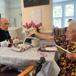 two people looking at a photograph together