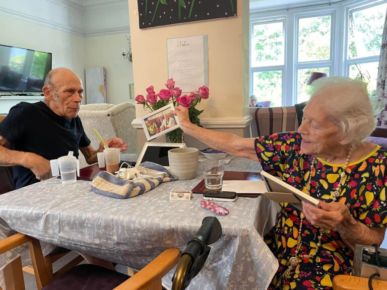 two people looking at a photograph together