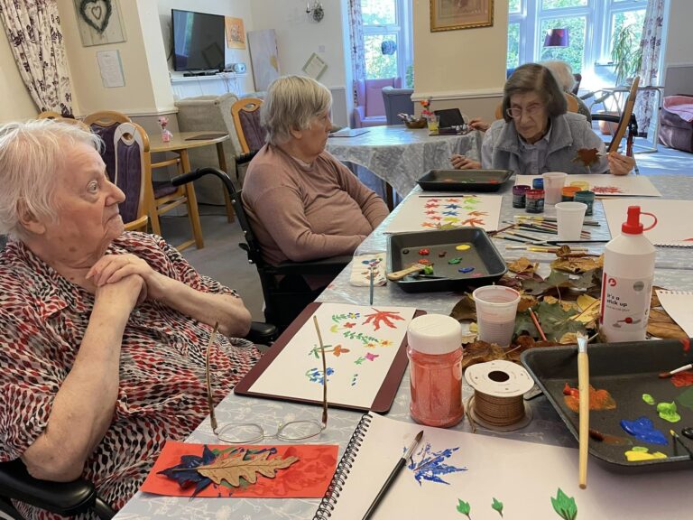elderly women gathered around a table