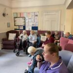 people in a care home tasting wine together