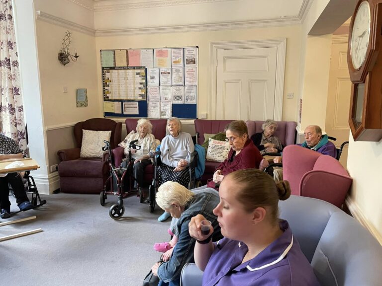 people in a care home tasting wine together