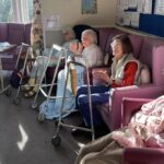 elderly people smiling with the sun shining
