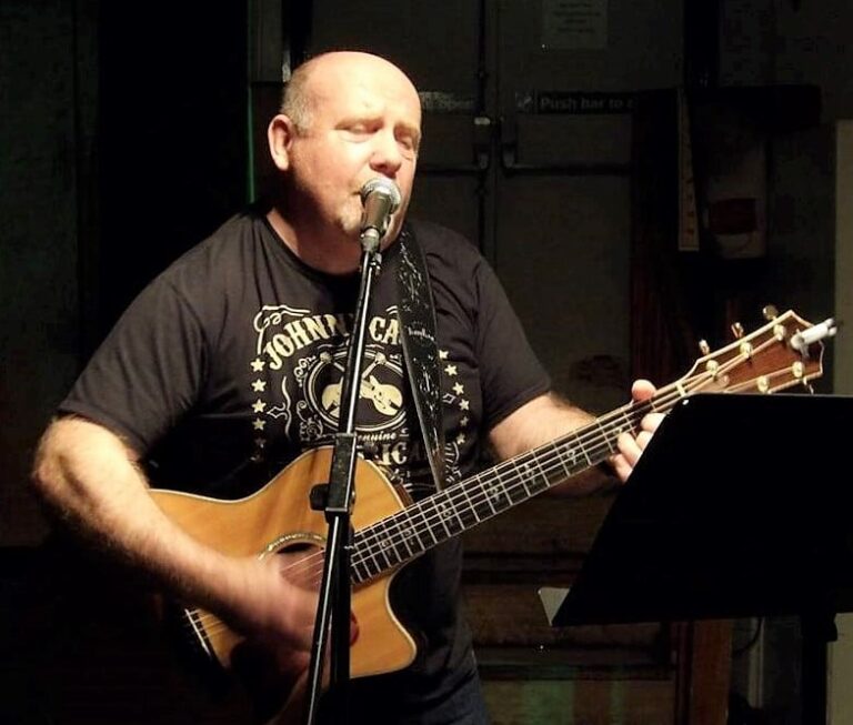 Kevin Russell playing the guitar