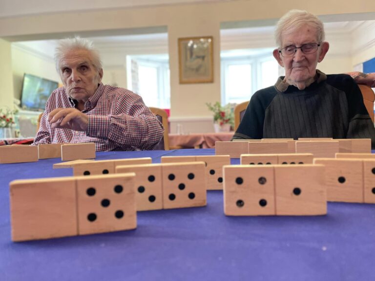 elderly fun playing dominoes at men's club