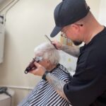 Ben Barton providing professional haircut at Hilgay Care Home for elderly gentlemen.