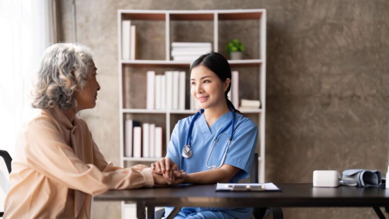 An elderly person and their caregiver in a Home Care setting.