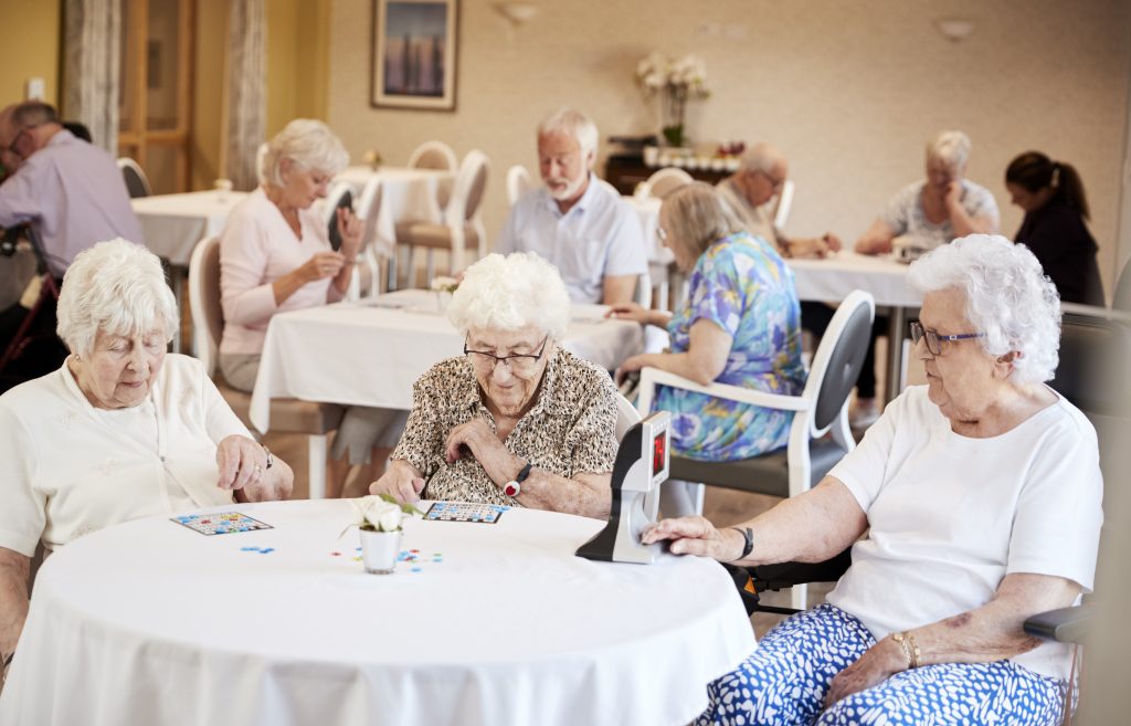 A standout choice for care homes in Burgess Hill West Sussex 3 A group of elderly residents playing a game of Bingo in care homes in burgess hill west sussex