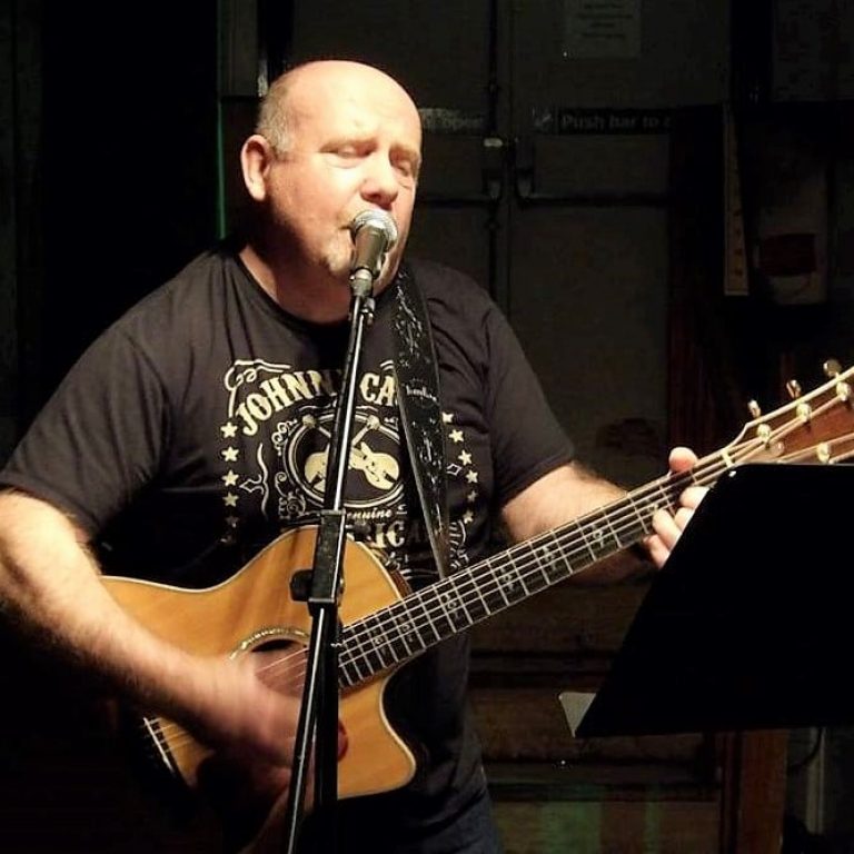 Kevin Russell playing the guitar