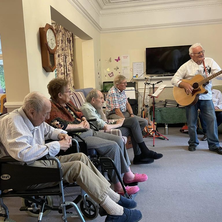care home residents listing to music performance