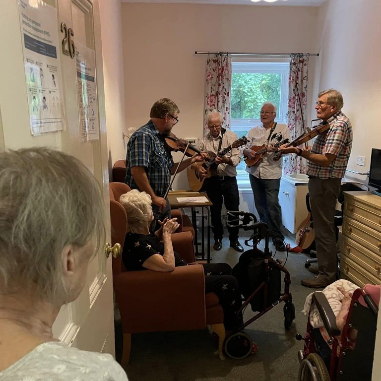care home residents listening to band