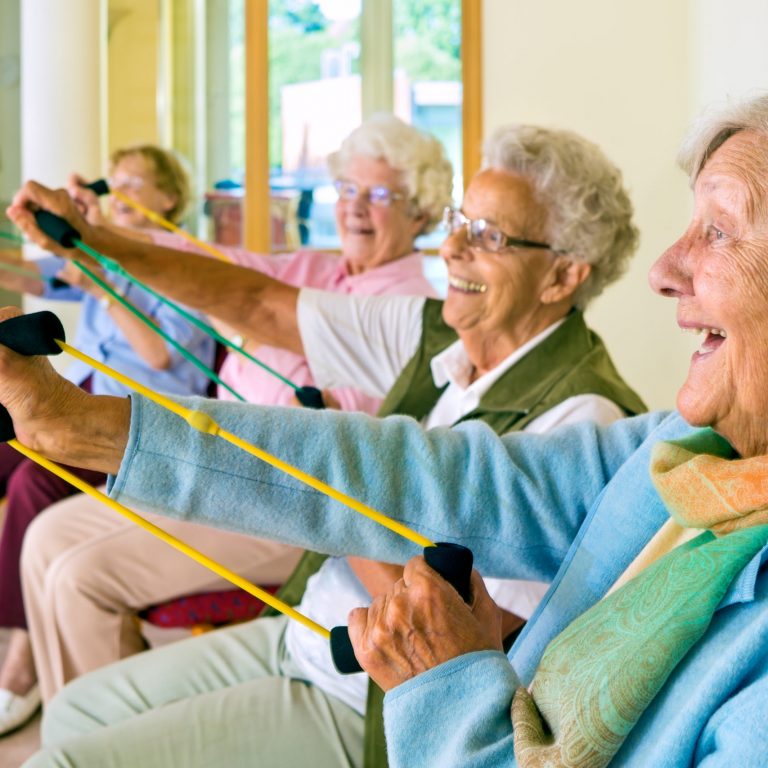 elderly people exercising at a care home