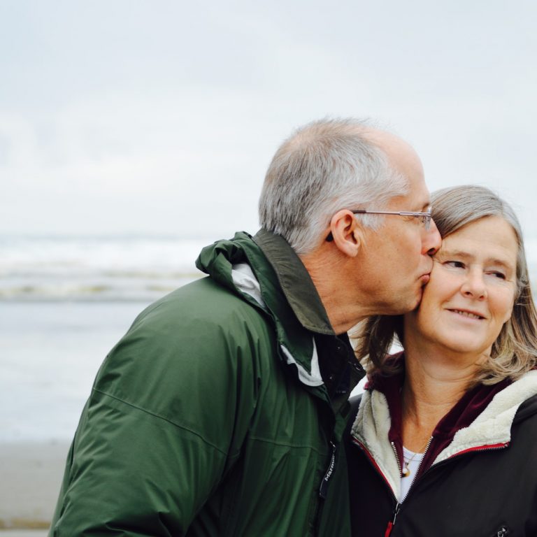 elderly man kissing woman