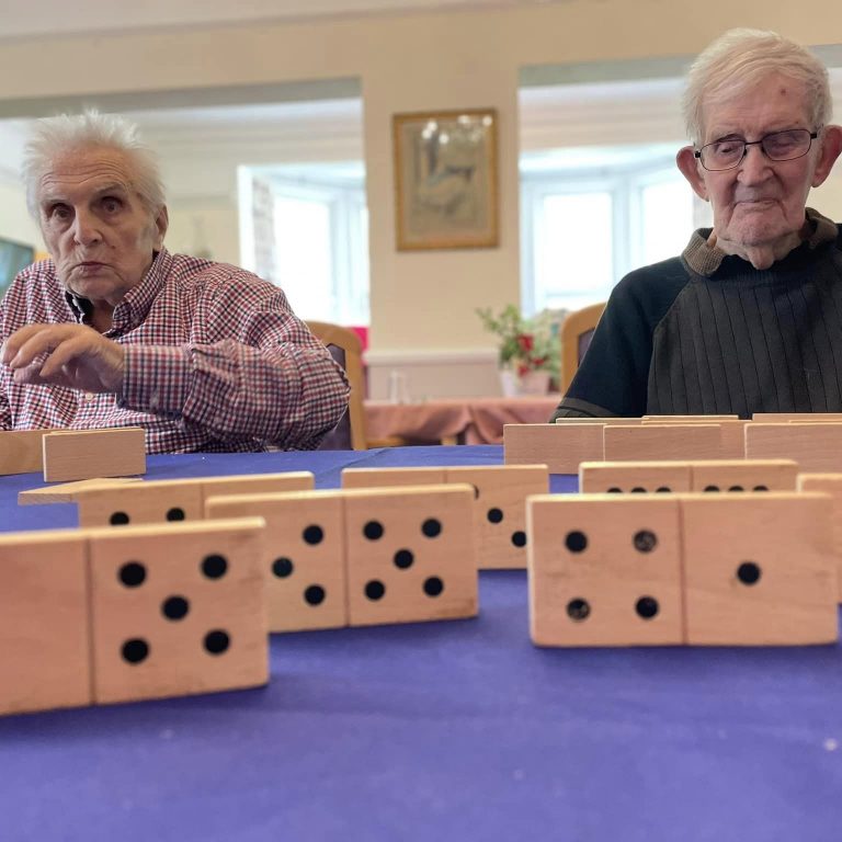 elderly fun playing dominoes at men's club