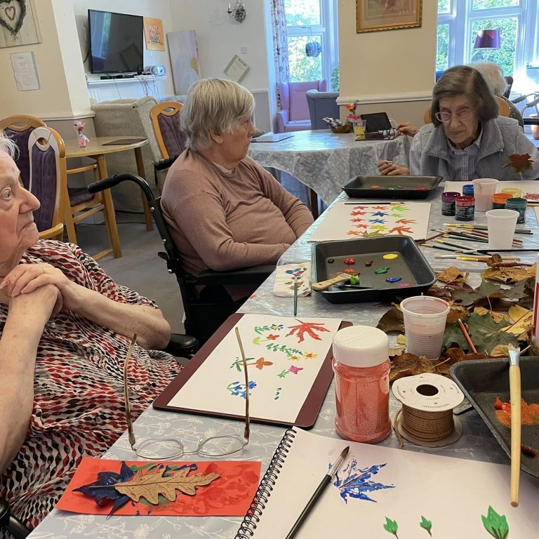 elderly women gathered around a table