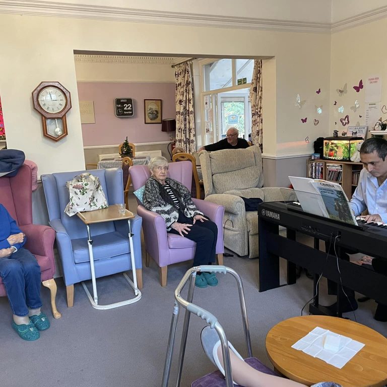 elderly women listening to pianist